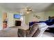 Spacious main bedroom features a ceiling fan, large windows, and an en suite bathroom at 10365 Lynnhaven Rd, Spring Hill, FL 34608
