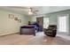 This is a main bedroom with a large window, ceiling fan and neutral decor at 10365 Lynnhaven Rd, Spring Hill, FL 34608