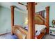 Spacious main bedroom featuring a statement canopy bed and calming decor at 10365 Lynnhaven Rd, Spring Hill, FL 34608