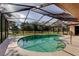 Inviting screened-in pool with clear blue water and view of the lush backyard at 10365 Lynnhaven Rd, Spring Hill, FL 34608