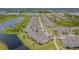 Aerial view of a townhome community featuring ponds and palm tree-lined streets at 10830 Verawood Dr, Riverview, FL 33579