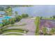 Aerial view of the parking area and dock near the lake, surrounded by well-maintained landscaping at 10830 Verawood Dr, Riverview, FL 33579