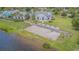 Scenic aerial view of community amenities including sandy beach, lake and community buildings at 10830 Verawood Dr, Riverview, FL 33579