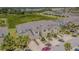 This is an aerial view of a townhome featuring neutral-colored siding and tropical landscaping at 10830 Verawood Dr, Riverview, FL 33579