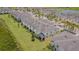 An aerial view of the townhouse exteriors with well-maintained lawns and landscaping in a lakeside community at 10830 Verawood Dr, Riverview, FL 33579