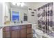 Bathroom featuring a vanity with a white countertop, dark wood cabinets and a shower behind a glass partition at 10830 Verawood Dr, Riverview, FL 33579