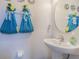 Bathroom featuring a pedestal sink, large mirror, and decorated hand towels at 10830 Verawood Dr, Riverview, FL 33579