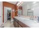 This bathroom features double sinks, a walk-in closet, and a glass enclosed shower at 10830 Verawood Dr, Riverview, FL 33579