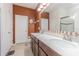 This bathroom features a double sink vanity with a white countertop and an elegant mirror at 10830 Verawood Dr, Riverview, FL 33579
