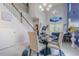 Bright dining area with tall ceilings, modern chandelier, staircase, and views of the open-concept living space at 10830 Verawood Dr, Riverview, FL 33579