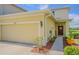 Charming two-story home with an attached garage, a well-maintained lawn, and a welcoming front entrance at 10830 Verawood Dr, Riverview, FL 33579
