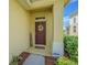 Inviting front entrance featuring a stylish door with a decorative wreath and a well-manicured landscape at 10830 Verawood Dr, Riverview, FL 33579