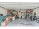 Spacious two-car garage with plenty of storage, shelving, and room for tools and equipment at 10830 Verawood Dr, Riverview, FL 33579