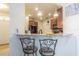 Kitchen bar seating area features dark wood cabinetry, granite countertops, and stainless steel appliances at 10830 Verawood Dr, Riverview, FL 33579