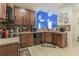 Modern kitchen featuring granite countertops, dark wood cabinetry, and an open design with a view to living area at 10830 Verawood Dr, Riverview, FL 33579