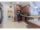 Well-equipped kitchen featuring modern appliances, granite countertops, and a functional layout with laundry access at 10830 Verawood Dr, Riverview, FL 33579