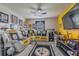 This fan themed living room features a large sofa and TV at 10830 Verawood Dr, Riverview, FL 33579
