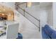 Open-concept living space with wood stairs, adjacent to the kitchen bar and featuring white cabinets at 10830 Verawood Dr, Riverview, FL 33579