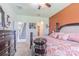 Bedroom featuring a large dark wood bed frame with bedside tables and dresser set at 10830 Verawood Dr, Riverview, FL 33579