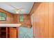 Retro bar area with wood paneling, window views, and built in seating at 11159 Cindy Dr, Brooksville, FL 34601