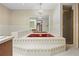 Bathroom with large red tub, floral wallpaper, shower, and double sinks at 11159 Cindy Dr, Brooksville, FL 34601