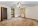 Bedroom featuring neutral carpet, ceiling fan, window views, and vintage wallpaper at 11159 Cindy Dr, Brooksville, FL 34601