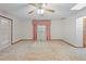 Bedroom with ceiling fan, light carpet, wallpaper, and large window with curtains at 11159 Cindy Dr, Brooksville, FL 34601