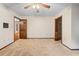 Spacious bedroom features carpet flooring, ceiling fan, closet, and vintage wallpaper at 11159 Cindy Dr, Brooksville, FL 34601