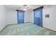 Bedroom with blue curtains and ceiling fan at 11159 Cindy Dr, Brooksville, FL 34601