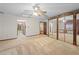 Bedroom featuring sliding mirror closet doors, light carpet, ceiling fan, and wallpaper at 11159 Cindy Dr, Brooksville, FL 34601