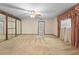 Bedroom features light carpet, wallpaper, ceiling fan, and large window with curtains at 11159 Cindy Dr, Brooksville, FL 34601