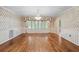 Formal dining room with hardwood floors, chandelier, and wainscoting at 11159 Cindy Dr, Brooksville, FL 34601