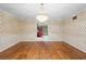 Dining room with hardwood flooring, classic wallpaper, and large chandelier at 11159 Cindy Dr, Brooksville, FL 34601