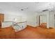 Hallway with view of bedroom, brown carpet, and chandelier at 11159 Cindy Dr, Brooksville, FL 34601
