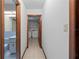 Hallway view leading to the laundry room with tile flooring and neutral walls at 11159 Cindy Dr, Brooksville, FL 34601