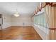 Living room featuring wood floors, large windows, and decorative curtains at 11159 Cindy Dr, Brooksville, FL 34601