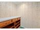 Storage room with wood cabinets and drawers; decorative wallpaper at 11159 Cindy Dr, Brooksville, FL 34601