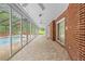 Spacious sunroom with tiled floor and screened in windows, offering a view of the pool at 11159 Cindy Dr, Brooksville, FL 34601