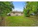 Well-maintained backyard featuring a lush green lawn, shade trees, and a peaceful outdoor space at 1116 Jadewood Ave, Clearwater, FL 33759