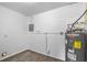 Utility room with a newer Rheem water heater on a concrete foundation at 1116 Jadewood Ave, Clearwater, FL 33759