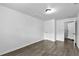Minimalist bedroom with wood-look floors and neutral wall color at 1116 Jadewood Ave, Clearwater, FL 33759