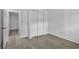 Bedroom features closet, door to bathroom, light colored walls and gray wood look flooring at 1116 Jadewood Ave, Clearwater, FL 33759