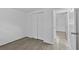 Bedroom features closet, door to bathroom, light colored walls and gray wood look flooring at 1116 Jadewood Ave, Clearwater, FL 33759