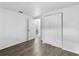 Bedroom with walk in closet, an attached bathroom, light colored walls and gray wood look flooring at 1116 Jadewood Ave, Clearwater, FL 33759