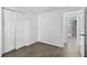 Bright bedroom featuring wood-look flooring, closet, and access to an ensuite bathroom at 1116 Jadewood Ave, Clearwater, FL 33759