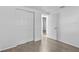 Bright bedroom with wood-look floors, closet, and interior doors at 1116 Jadewood Ave, Clearwater, FL 33759