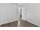 A clean, light-filled bedroom shows neutral walls and gray wood-look flooring at 1116 Jadewood Ave, Clearwater, FL 33759