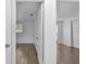 View through doorway to bedroom with wood-look floors and window at 1116 Jadewood Ave, Clearwater, FL 33759