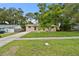 Charming home featuring a lush front lawn, inviting curb appeal, and a well-kept exterior at 1116 Jadewood Ave, Clearwater, FL 33759