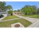 Inviting home featuring a well-manicured lawn, mature trees, and a neatly maintained facade at 1116 Jadewood Ave, Clearwater, FL 33759